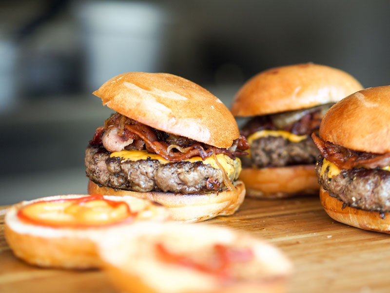 close-up of small burger with bacon and cheese
