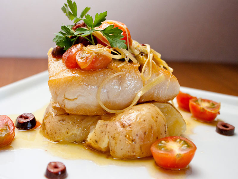 close-up of fish with tomatoes and herbs