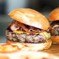 close-up of small burger with bacon and cheese