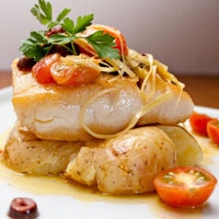 close-up of fish with tomatoes and herbs